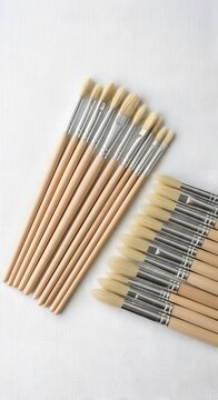 Bundle of unsharpened wooden pencils on white wooden background minimalist flat lay