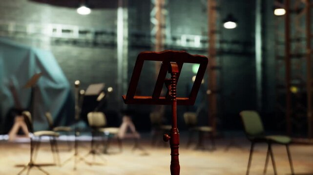 The old opera stage features empty chairs and a music stand, hinting at an upcoming performance in a vintage theater setting that exudes history and charm.
