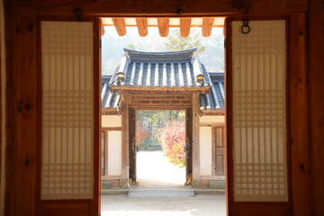 Traditional Korean Hanok House Interior View with Wooden Door Frame and Tiled Roof