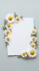 Obraz premium A white paper is surrounded by a beautiful arrangement of daisies.