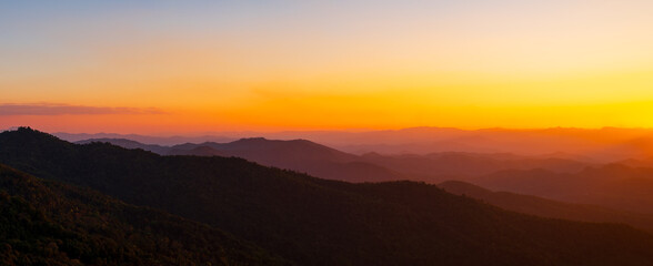 Naklejka premium Beautiful natural panoramic countryside landscape with mountains at sunset. Rainforest ecosystem and healthy environment concept background. Nature background.