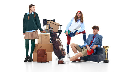 Fototapeta premium Teen students posing with boxes, golf bag and trophy isolated on white. Concept of achievement, extracurricular activities, youth ambition and academic lifestyle branding.