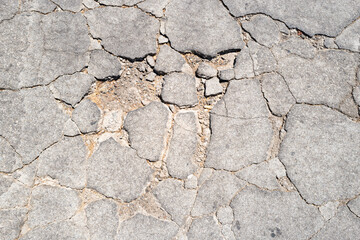 Obraz premium Texture cracked asphalt surface. Texture damaged road background. Texture rough concrete detail. Texture urban pavement pattern.