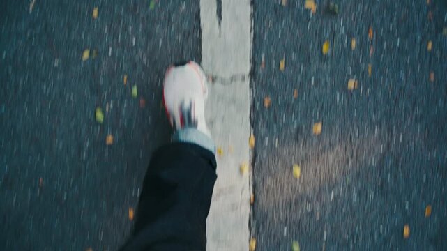POV Shot of Person Walking the Wrong Way Against Road Arrow Marking