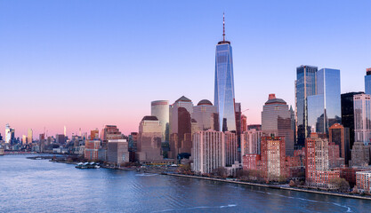 Obraz premium New York City skyline with skyscrapers at sunset. NYC night skyline with Manhattan. New York panoramic cityscape. New York City aerial view of Manhattan. New York skyline with Tower at sunset.