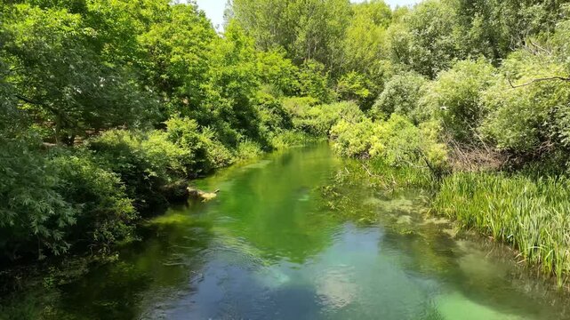 Drone closely following idillic river in the countryside 4k drone