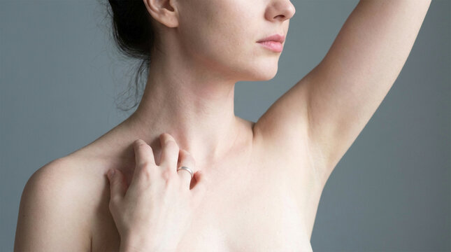 Young woman scratches her neck and collarbone area with her fingers, indicating potential skin irritation or itchiness.
