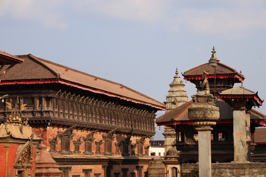 Historic temples and traditional Newari architecture at Bhaktapur Durbar Square, Nepal. UNESCO World Heritage site showcasing pagoda roofs, carved wood windows, and rich cultural heritage.