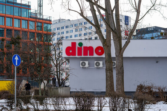 Dino supermarket building in the city center with modern office towers featuring 3M, CCC, and OVHcloud logos, winter urban landscape, commercial and business architecture, retail infrastructure, and c