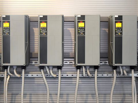 Industrial frequency converters mounted on a wall in a gas boiler room
