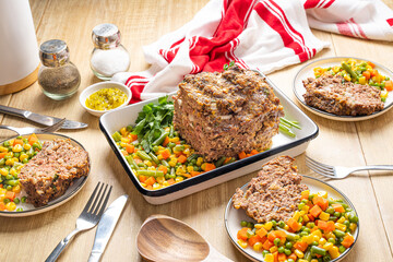 American dinner food. Ground beef meatloaf with vegetables