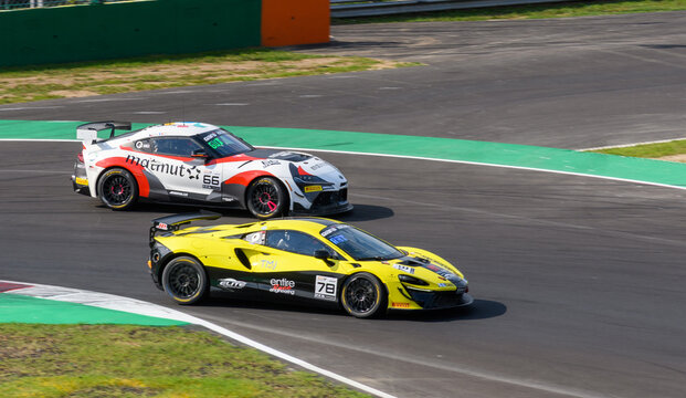 GT race cars fight for position at Autodromo Nazionale Monza, blasting through chicanes and long straights, showcasing speed, aerodynamics, and elite motorsport action.