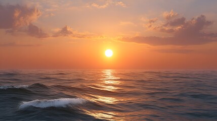 Obraz premium A spectacular sunset paints the ocean horizon with vibrant orange and pink hues reflecting golden light on gentle waves under a cloudy sky