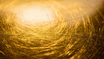 Obraz premium Abstract golden surface with intricate scratch patterns, close-up texture, warm light, dark background, rich visual detail for design elements