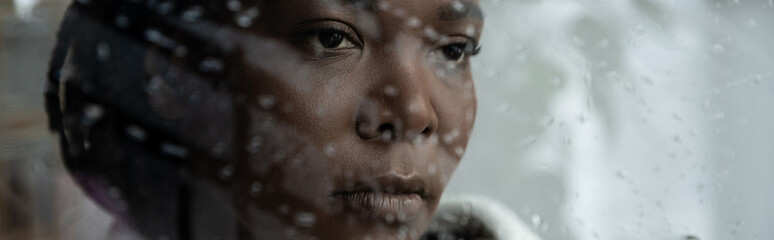 Obraz premium Feeling the heaviness of loneliness inside a quiet home on a rainy day