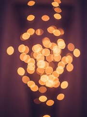 Warm orange bokeh lights on dark background with blur effect