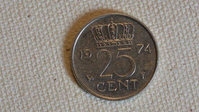 Close-up of a 1974 Netherlands 25 Cent Nickel Coin with Royal Crown Symbol.
