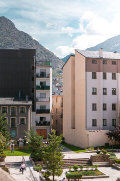 Plaza of Jardins Casa de la Vall in Andorra La Vella Old Town with views of residential buildings and Pyrenees mountains in the background