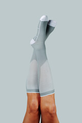 gray compression socks on upside down legs