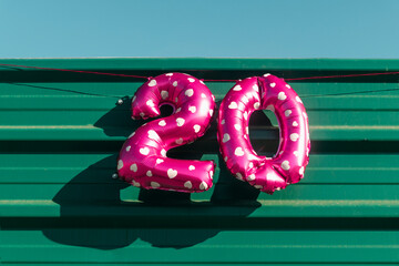 the number 20 displayed with pink balloons