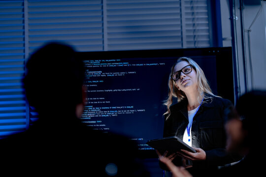 Call center perspective female agent headset microphone glasses focused attentive listening customer query complex issue requires deep concentration modern support hub blue light ambiance.