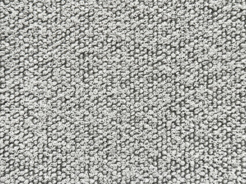 Close up texture of black and white boucle fabric. Curled and nubby knitted tufted texture. Suitable for sofa, upholstery, curtain, and drapery. Seamless background fabric texture.
