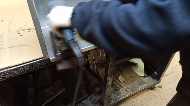 Sanding and cleaning metal cabinets to remove scratches for a clean finish.