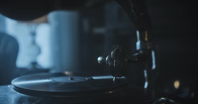 Handheld, silhouette shot of working gramophone and fireplace in spooky living room - closeup