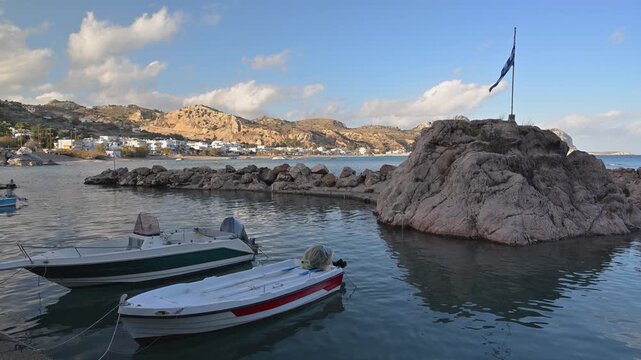 Boats near a rocky coastal outcrop at Stegna on Rhodes island in Greece