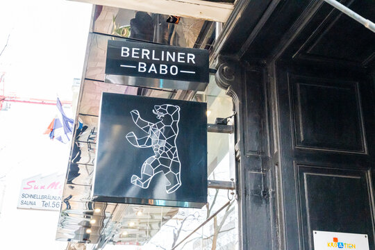 Vienna, Austria- Feb 21, 2026: A modern black and white sign featuring a geometric bear logo at Berliner Babo restaurant, showcasing contemporary design and urban dining culture.