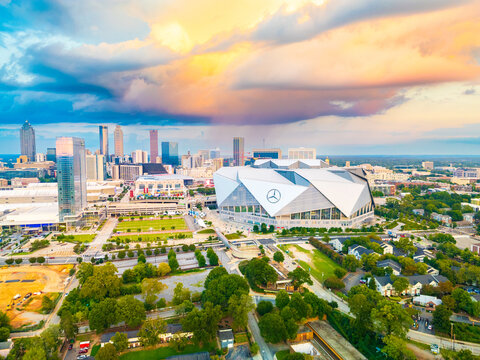 Elevated cityscape showing Mercedes-Benz Stadium and the central business district at sunset.