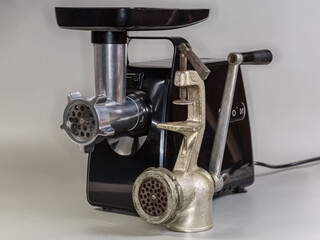 Modern household electric meat grinder and vintage hand meat grinder