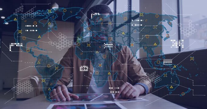 Analyst tapping and sliding prints as world map appearing and mapping onto prints for analysis