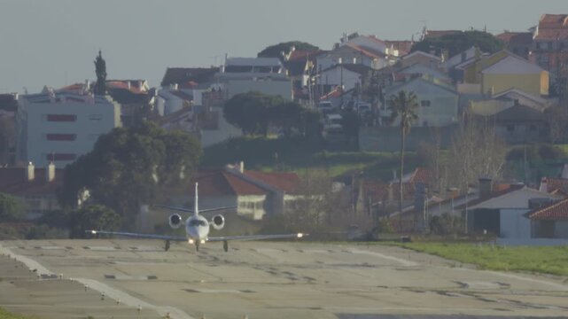 Private business jet landing on runway