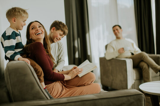 Family enjoys reading time together in a cozy living room