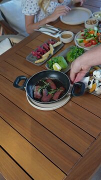 Delicious Turkish breakfast with sucuk and fresh vegetables served on a wooden table