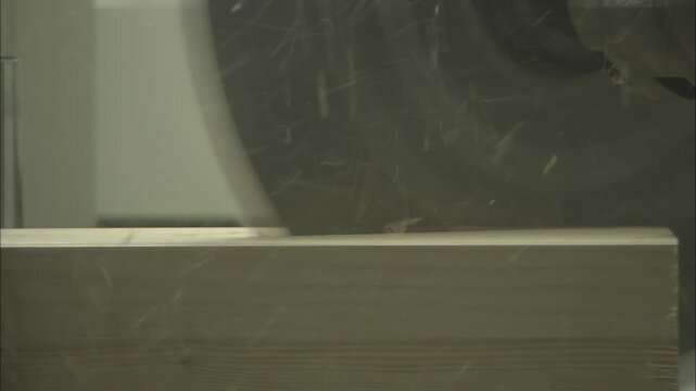 Industrial circular saw cutting precision notch in wooden beam
