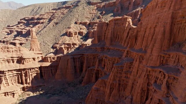 eroded sandstone desert canyon in Kyrgyzstan, dolly forward drone view
