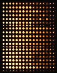 Grid Pattern of Illuminated Round Bulbs in Varying Brightness on Black