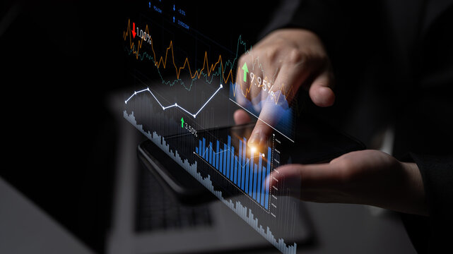 A close-up view of a person using a tablet to analyze financial data using graphs and statistics, highlighting market trends for smarter investment decisions. Scalp