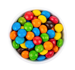 Colorful chocolate candies filling white bowl with transparent background