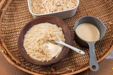 Milk Poured Over Pounded and Flattened Green Rice Cereal, known as Cốm in Vietnam, Ambok in Cambodia, Pinipig in the Philippines, and Matago in Zambezia, Mozambique