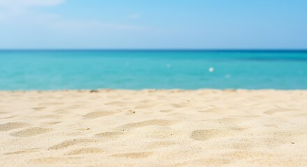 Obraz premium Beach sand and sea water on a sunny day with blue sky beautiful natural scenery