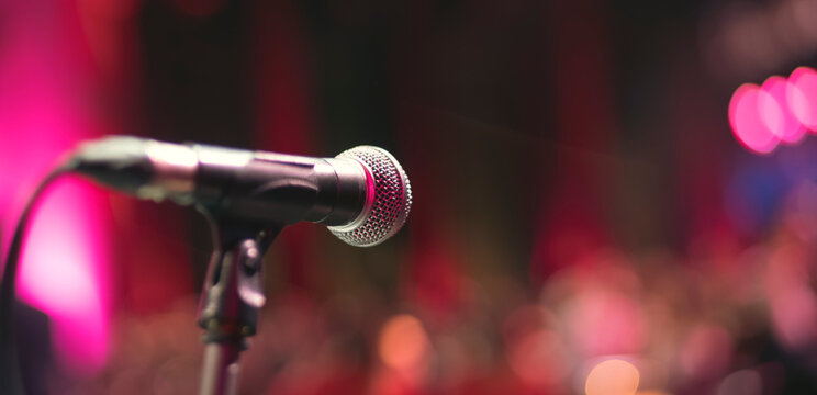 Dynamic Close-up of Vocal Microphone in Vibrant Stage Lighting