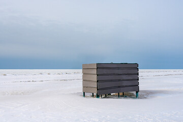 Lonely Beach Changing Room on Frozen Baltic Sea Coast in Winter © Zigmunds