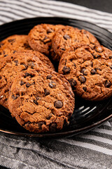 Fototapeta premium Chocolate cookies with chocolate chips sweet dessert homemade baking tasty snack fresh gourmet food background on the table rustic food top view copy space marketing concept photo