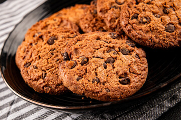 Fototapeta premium Chocolate cookies with chocolate chips sweet dessert homemade baking tasty snack fresh gourmet food background on the table rustic food top view copy space marketing concept photo