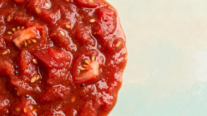 Obraz premium Macro close up of thick chunky red tomato sauce with visible seeds and glossy wet surface