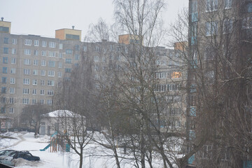 Winter Residential Courtyard with Apartment Blocks and Bare Trees on Foggy Day
