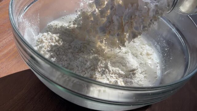 Adding Flour to Water and Starter for Sourdough